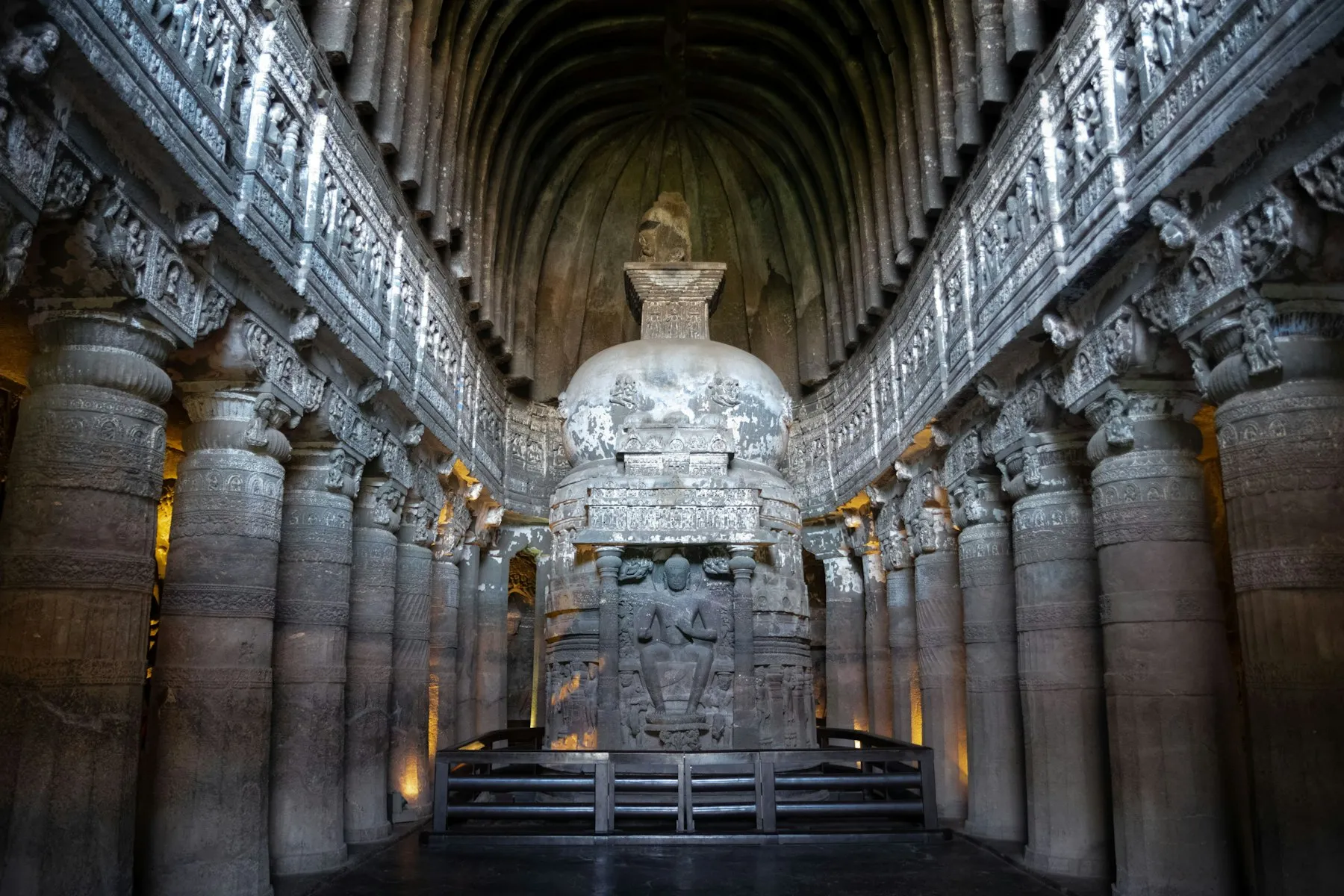 The rock-cut Buddhist façades of the Ajanta Caves curving along a cliff