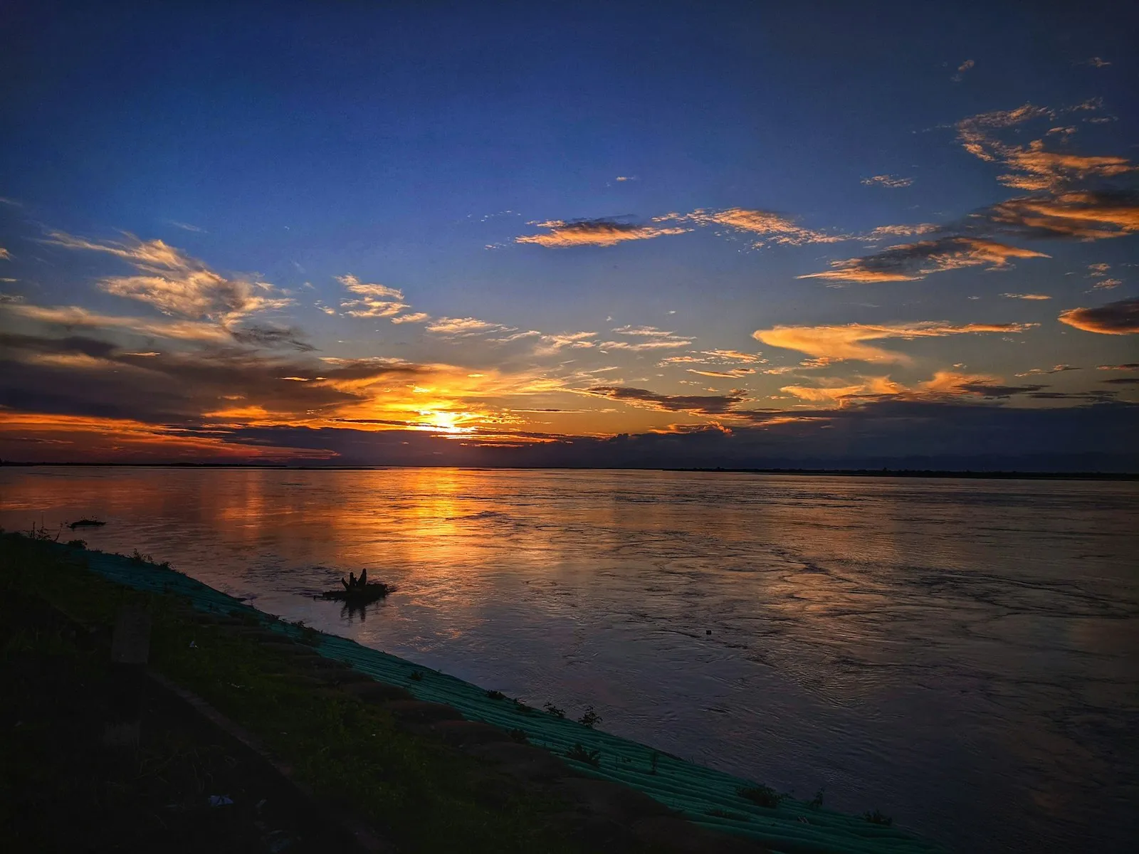 Sunset over the wide waters of the Brahmaputra in Assam