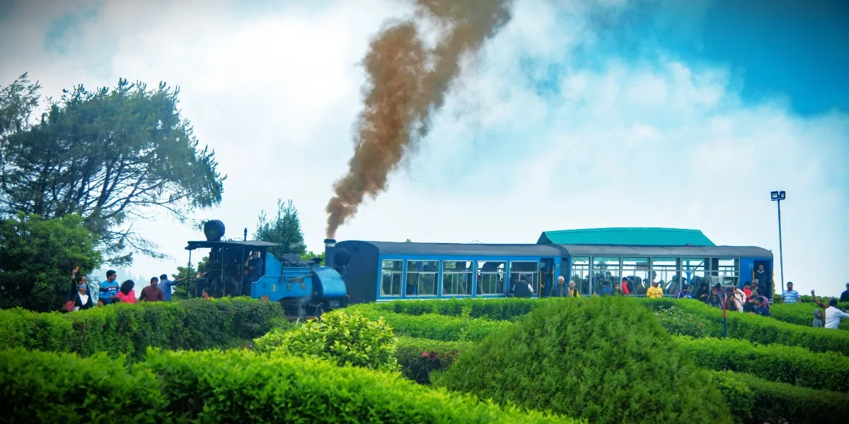 Blue steam toy-train locomotives raising steam at the Darjeeling Himalayan Railway