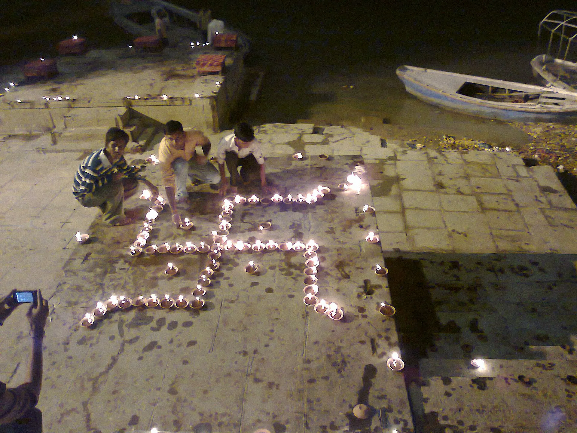 Oil lamps arranged in patterns on the ghats of Varanasi during Diwali