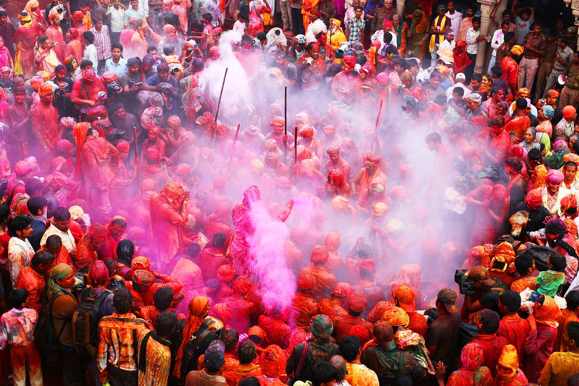 Crowds covered in coloured powder during the Holi festival at Barsana