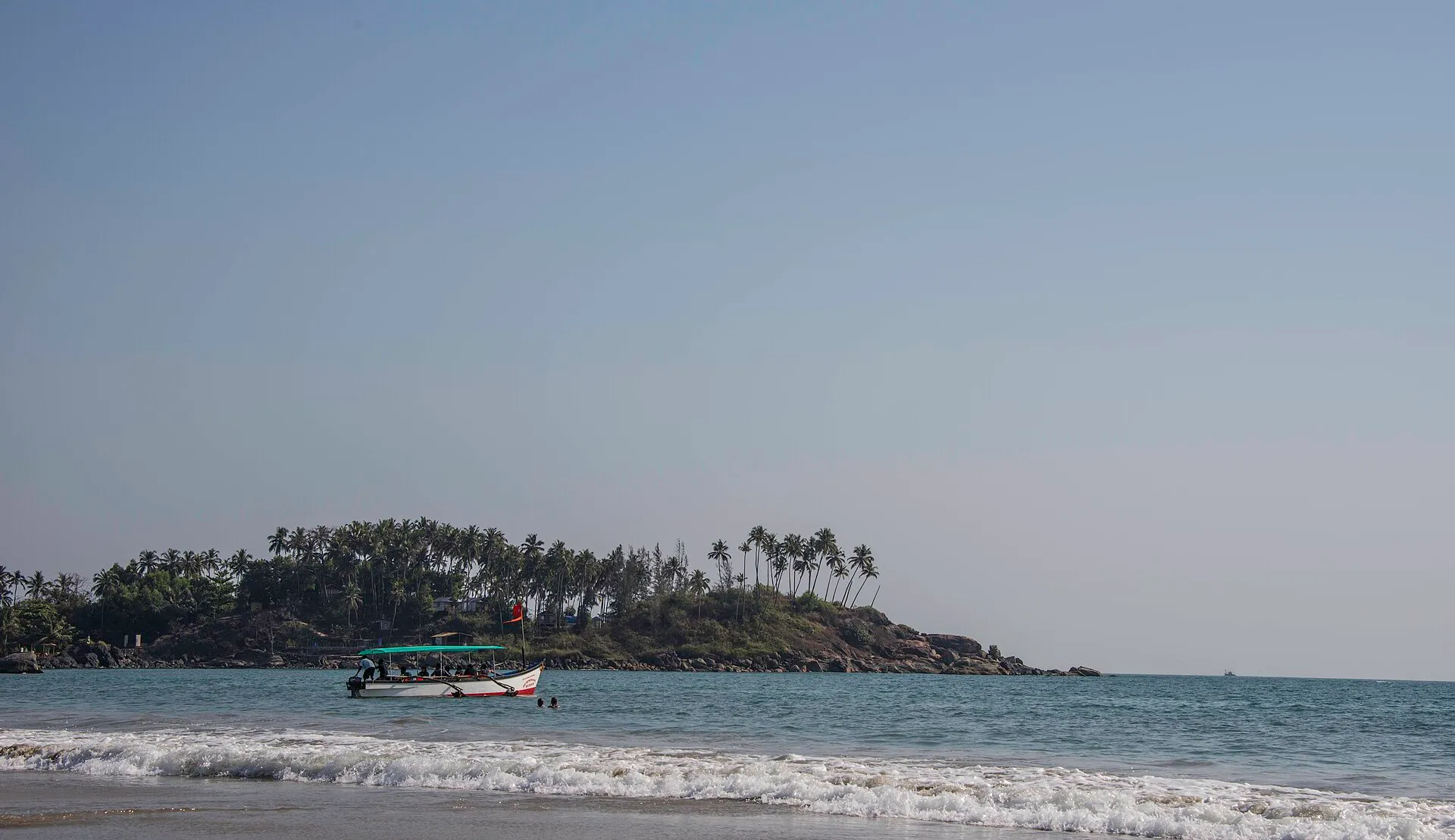 The crescent of Palolem Beach in south Goa fringed by palm trees