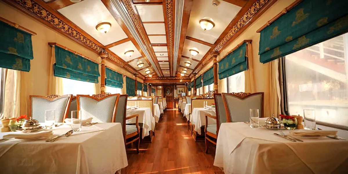 The opulent lounge car of the Golden Chariot, set with carved chairs and chilled champagne