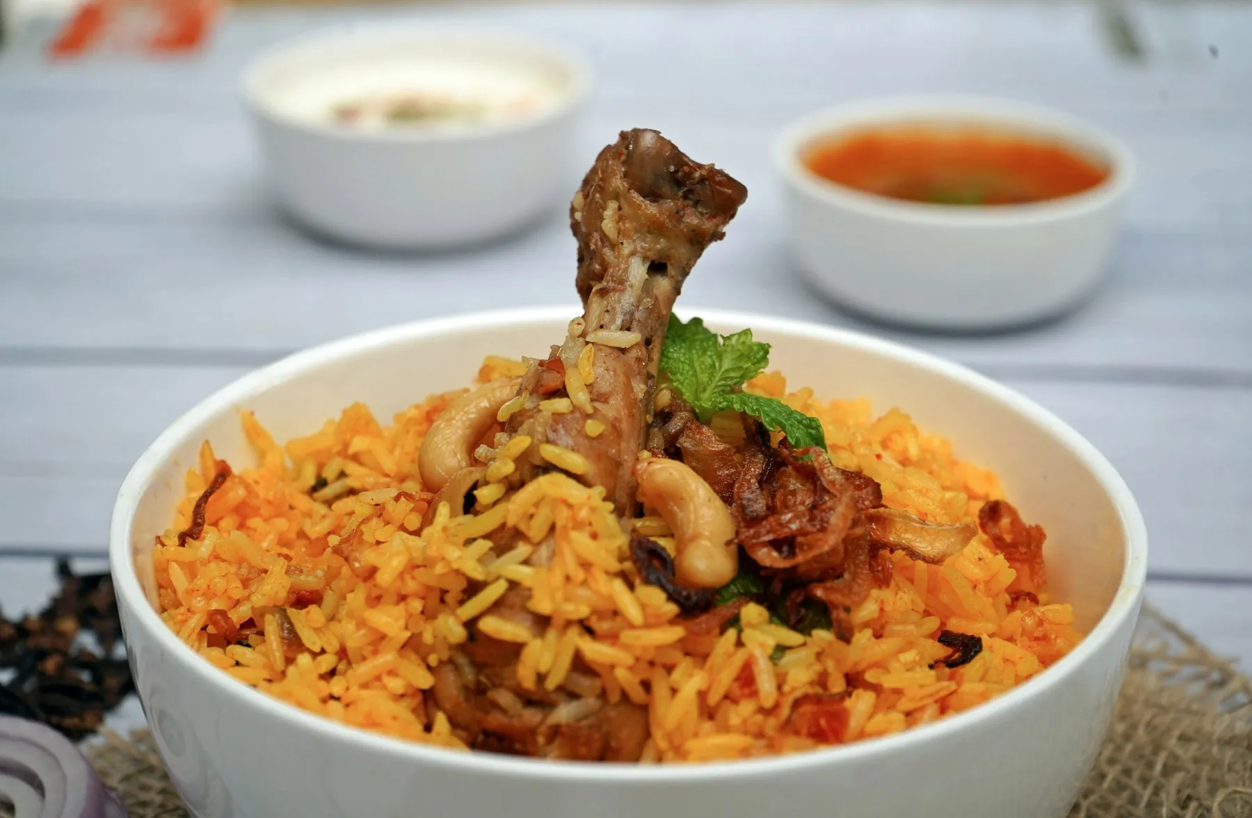 A handi of Hyderabadi chicken biryani layered with saffron rice