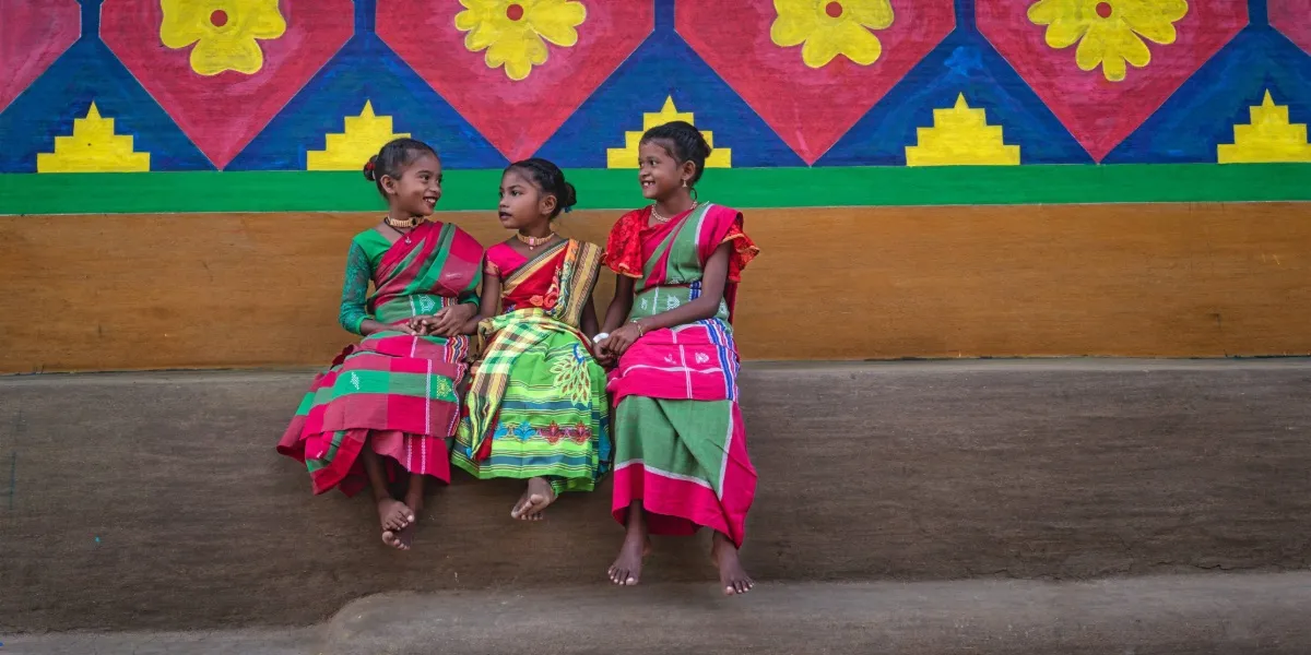 Santhal dancers and drummers in striped ceremonial dress at the Baha Porob festival in Jharkhand