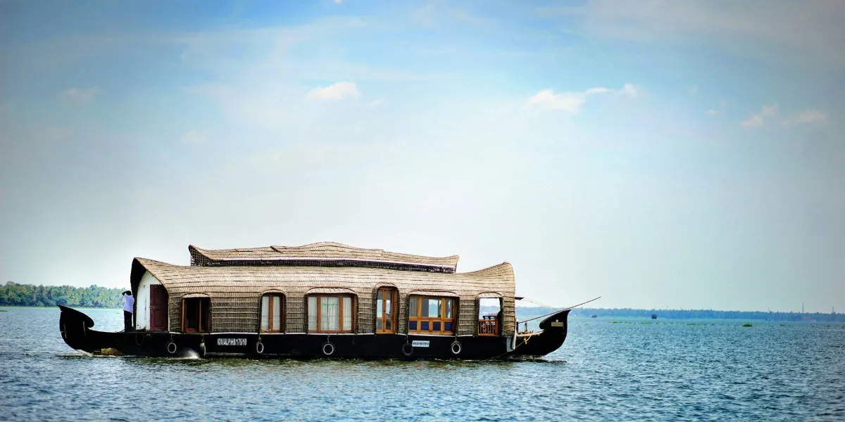 A traditional houseboat moored on the palm-fringed Alleppey backwaters in Kerala