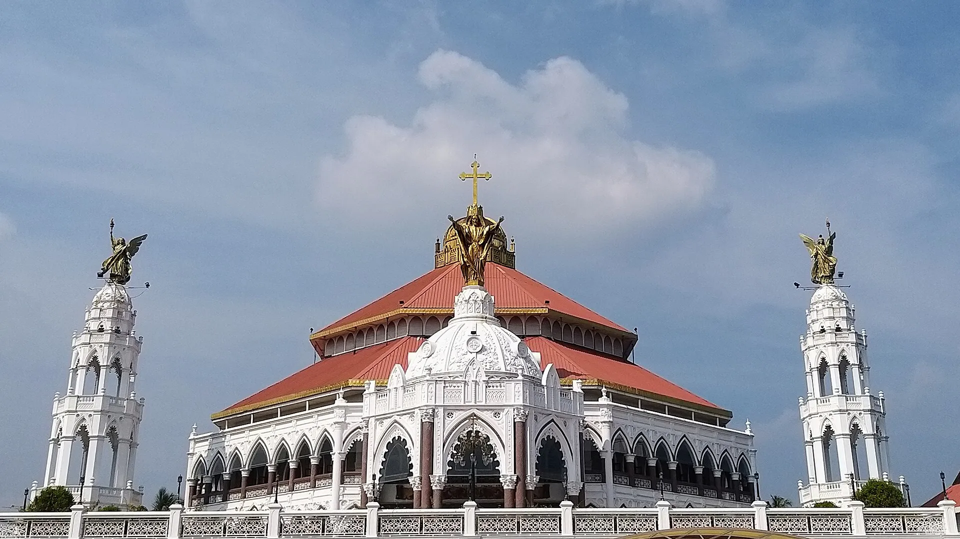 A whitewashed Syrian Christian church with a tiled roof in Kerala