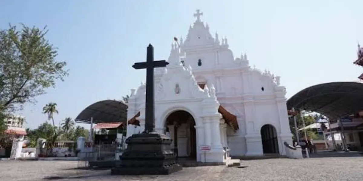A whitewashed Syrian Christian church with a tiled roof in Kerala