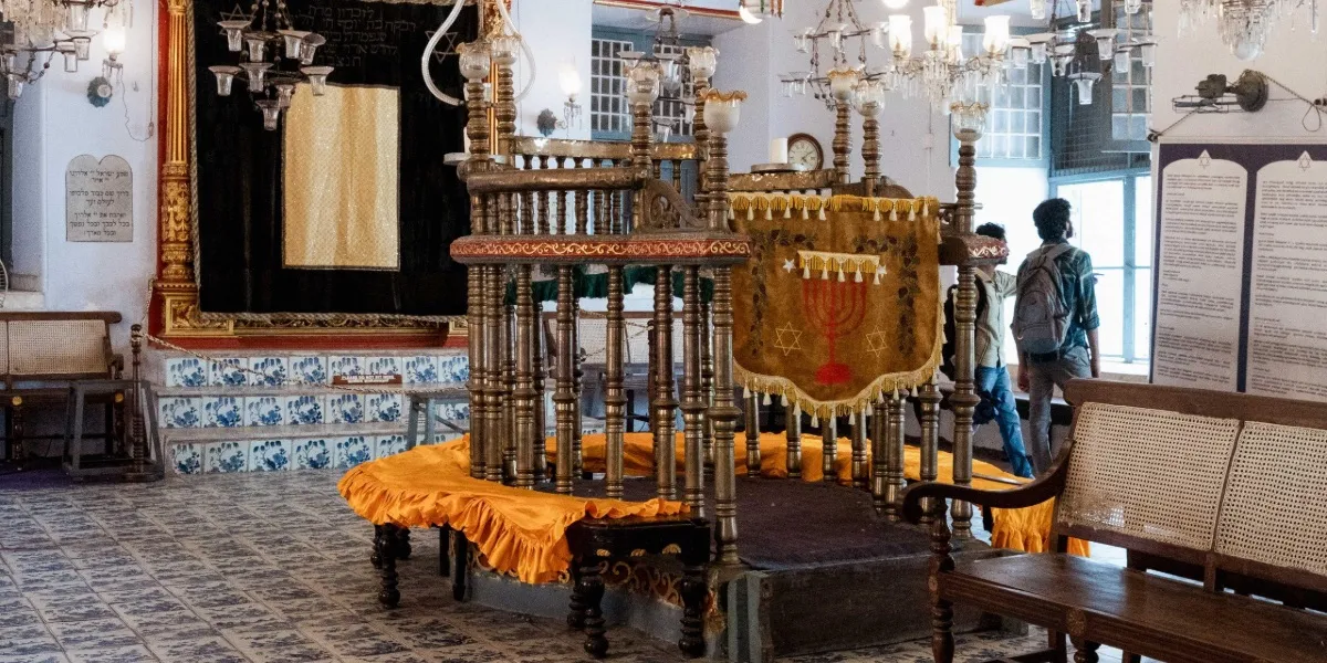 The interior of the Paradesi Synagogue with hanging lamps in Jew Town, Kochi