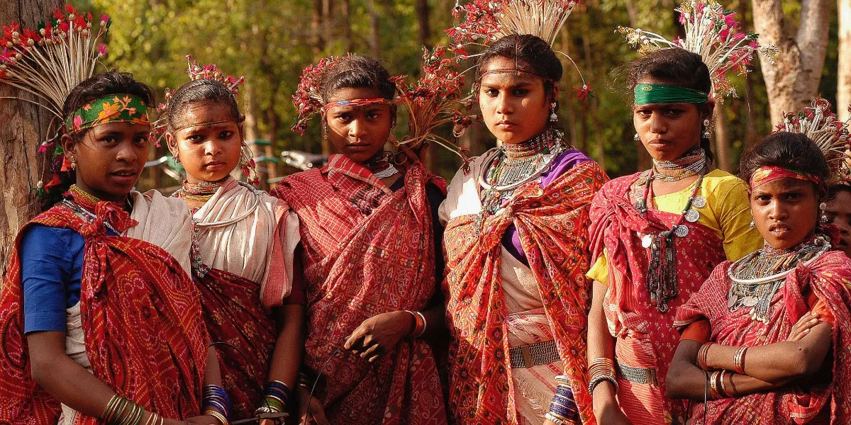 Painted wooden dance sticks and a drum laid out for a Gond tribal stick dance in central India
