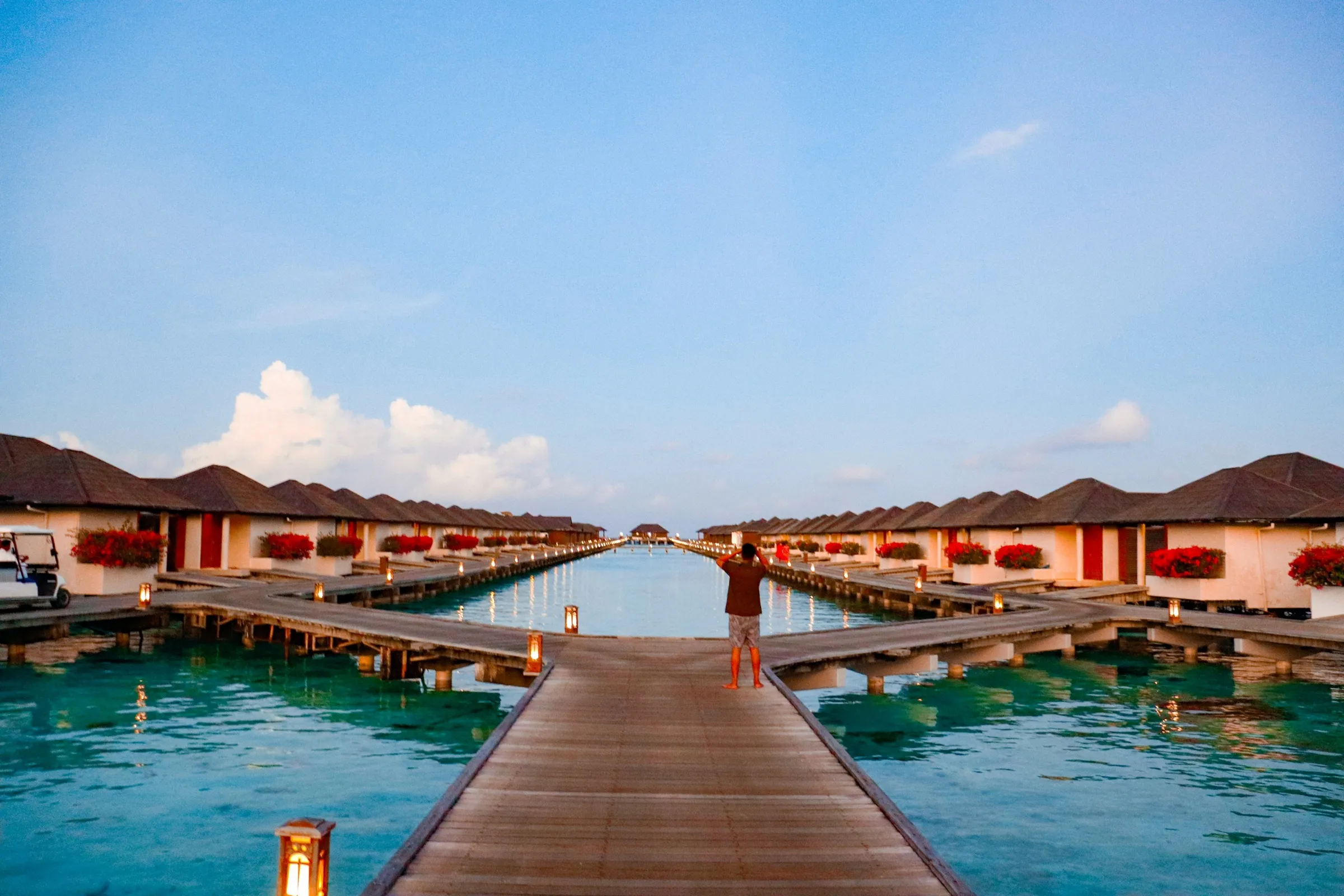 Overwater villas suspended above a turquoise Maldivian lagoon