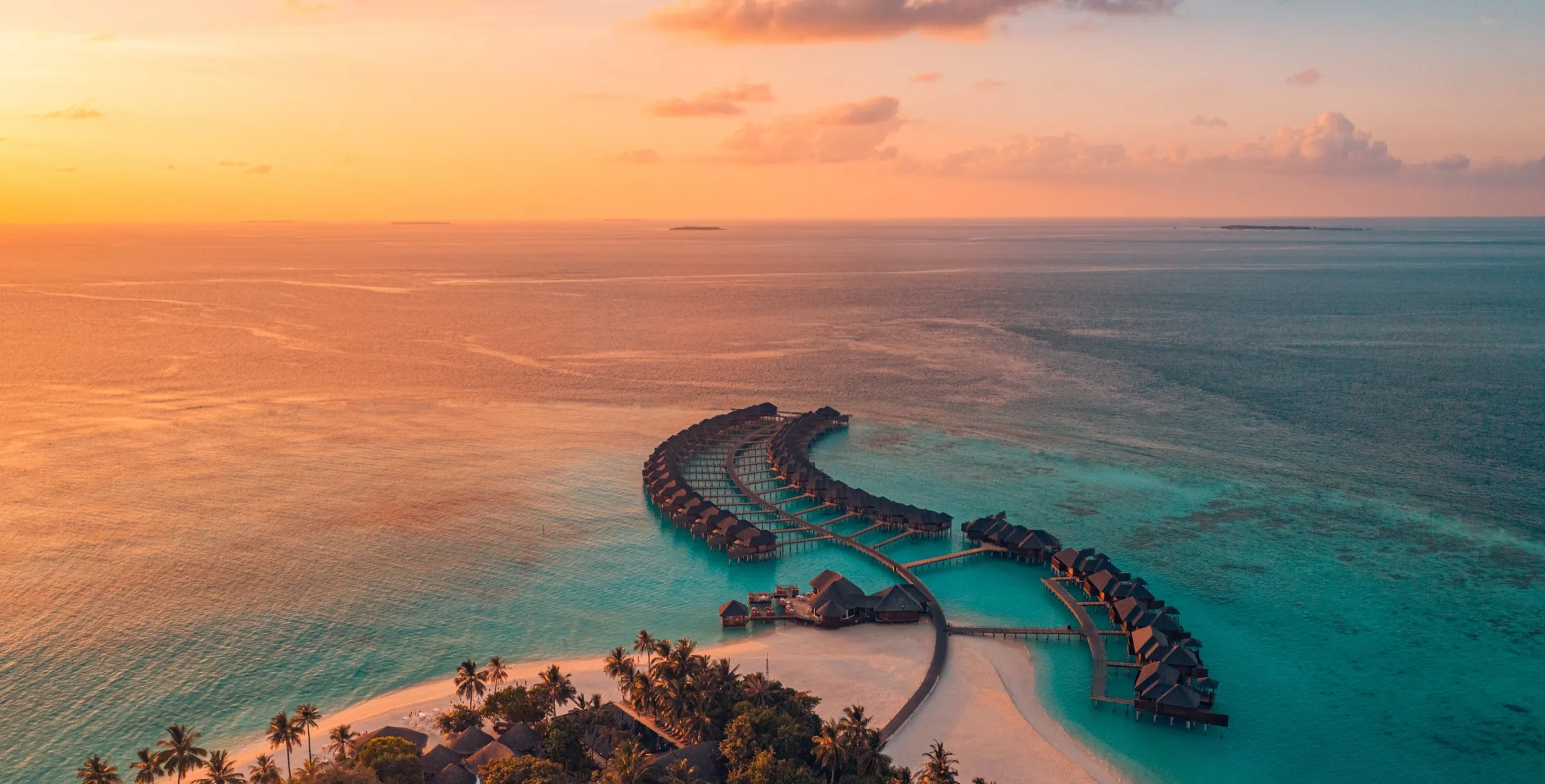Overwater villas above a turquoise Maldivian lagoon