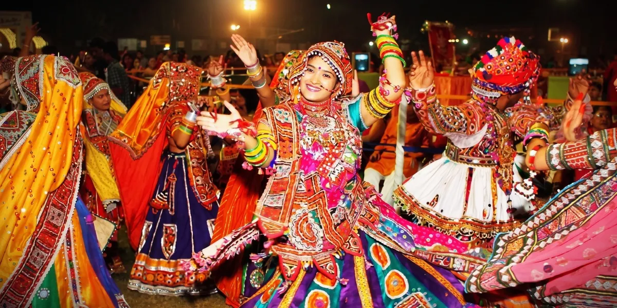 Dancers in traditional dress performing Garba in a circle during Navratri