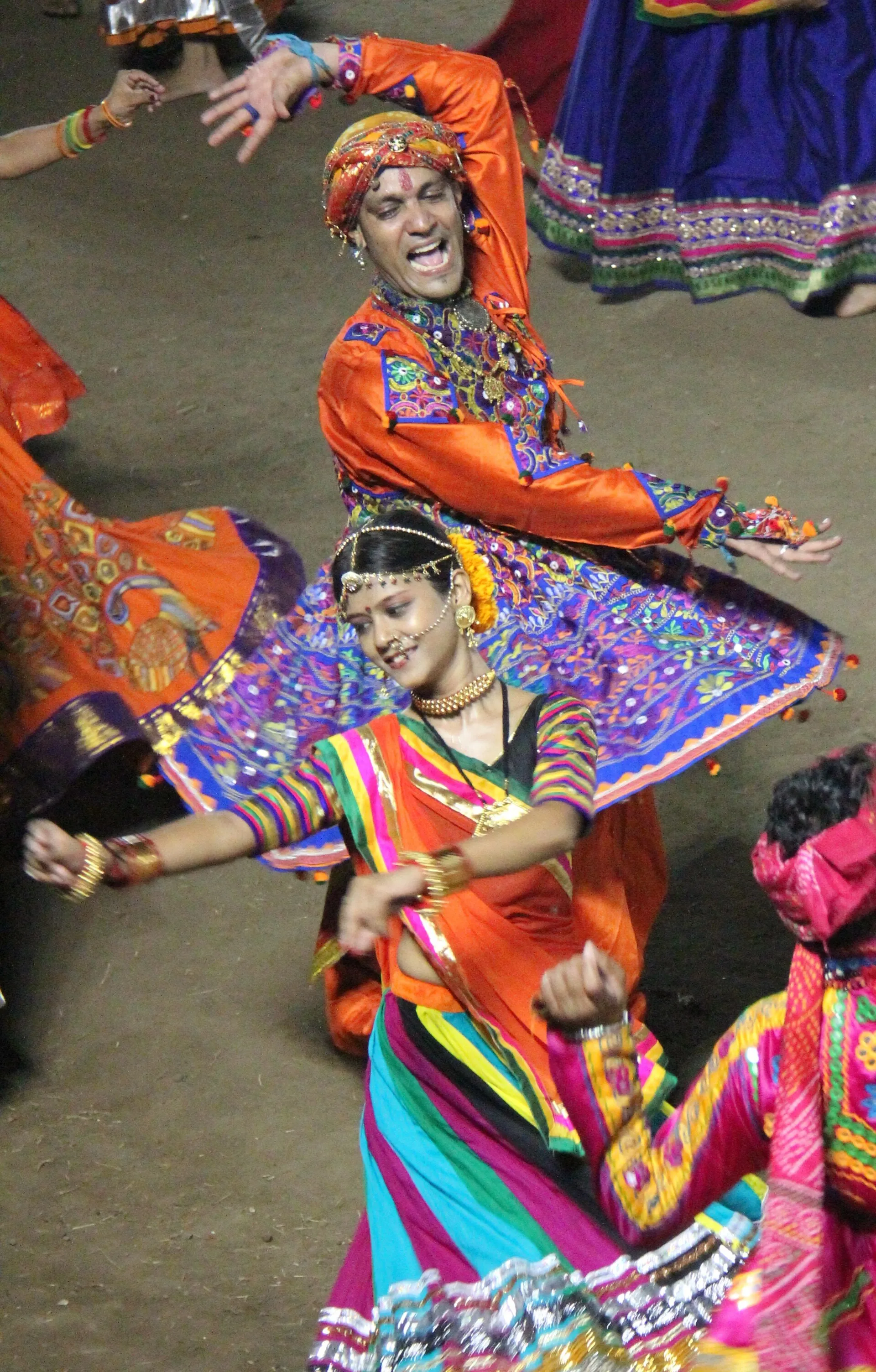 Dancers in traditional dress performing Garba in a circle during Navratri