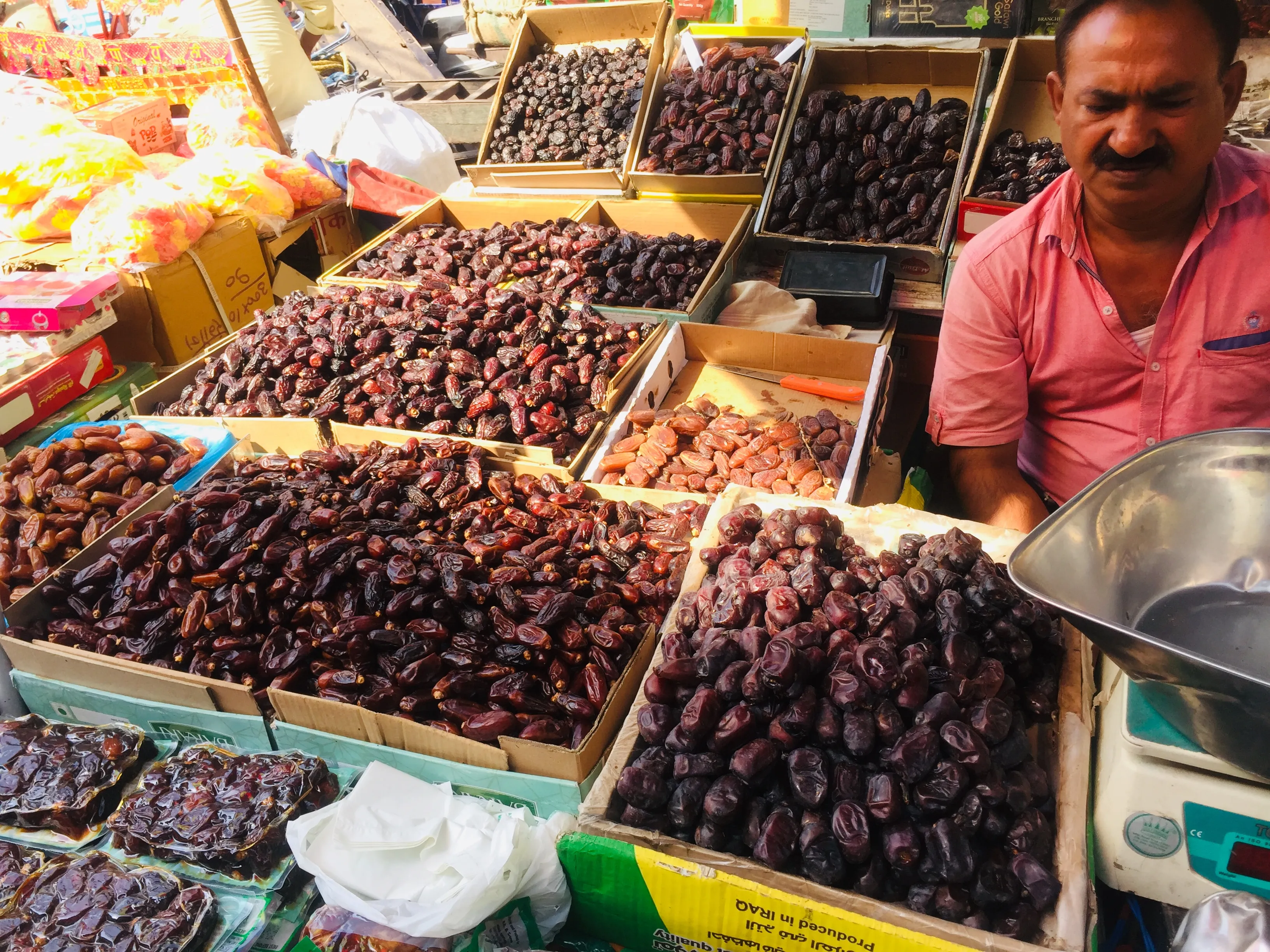 Sacks of dates and dry goods at a vendor's stall in the Khari Baoli spice market of Old Delhi