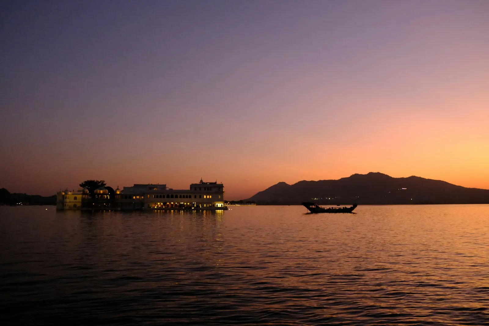 The Taj Lake Palace glowing at dusk on Lake Pichola, Udaipur
