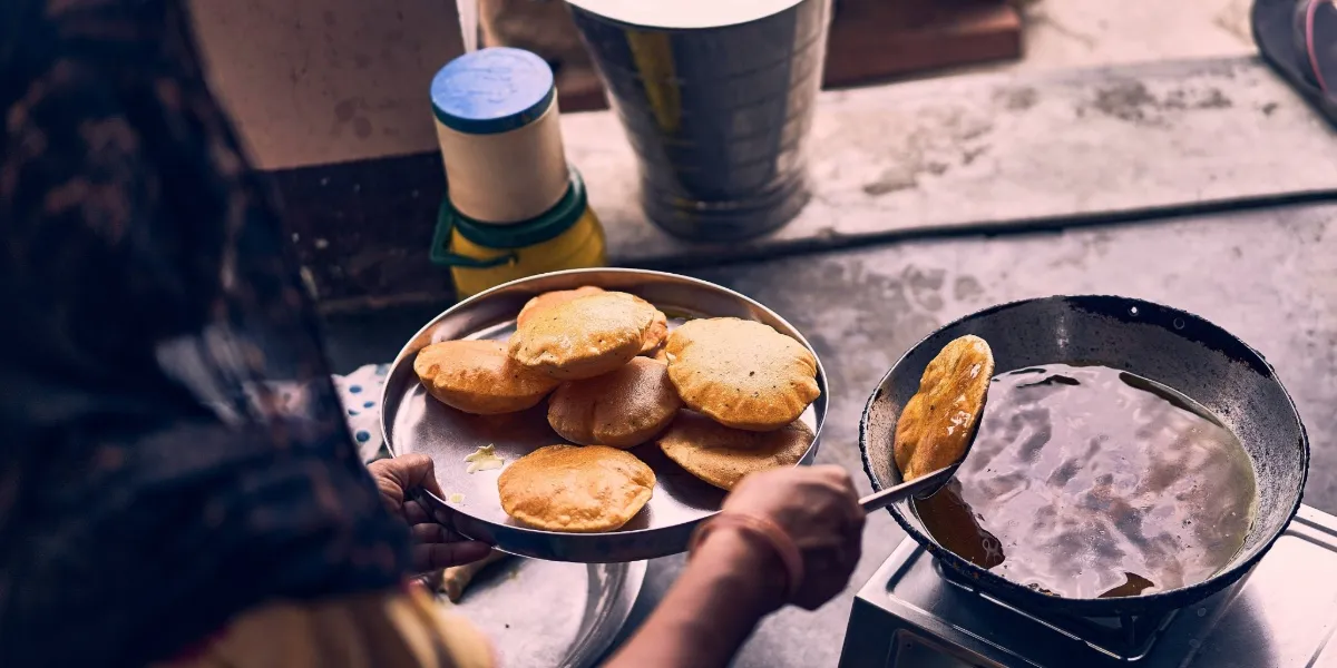 A bowl of sarson da saag served with makki di roti, a Punjabi winter classic