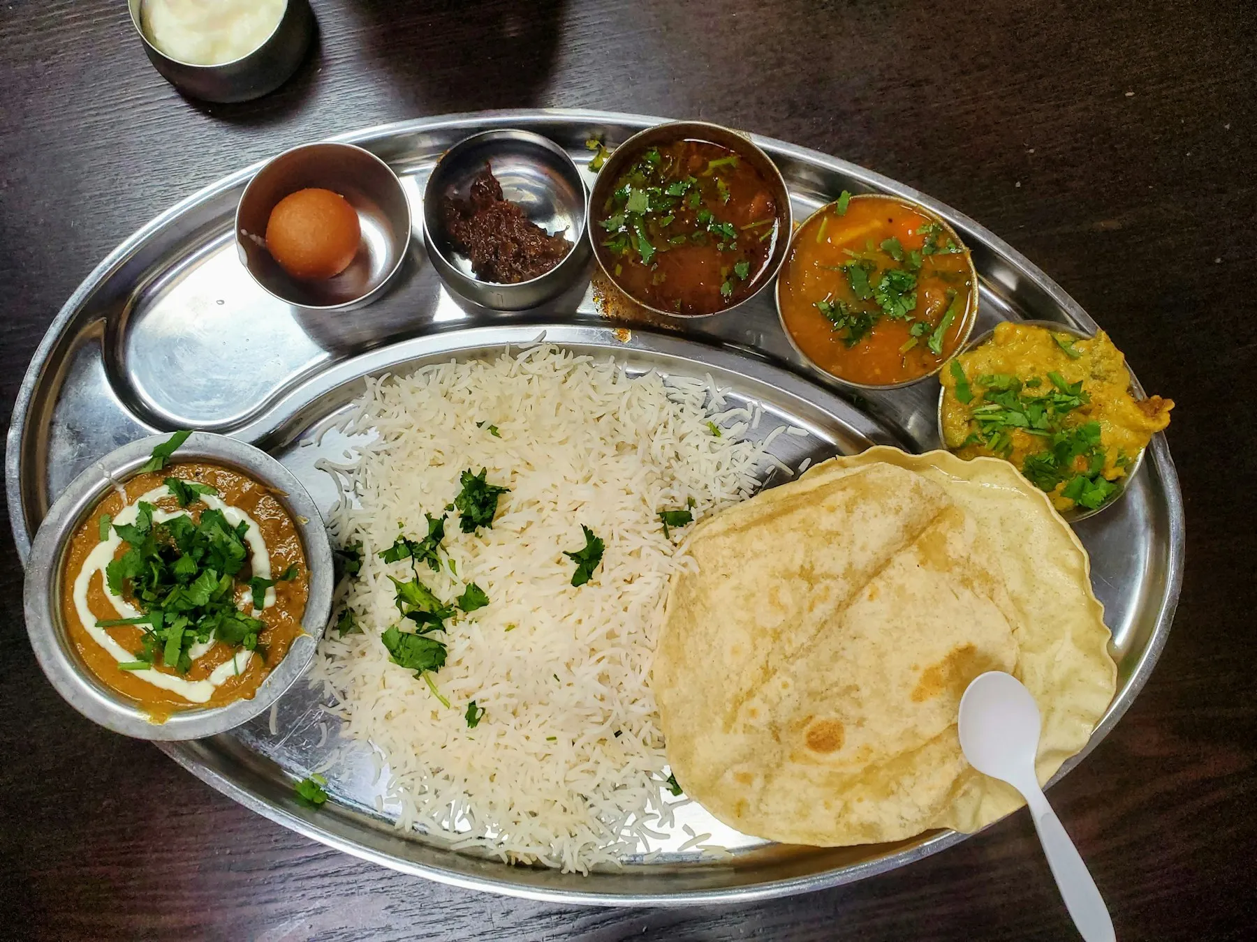 A traditional Rajasthani thali spread with regional curries, breads and dal-baati