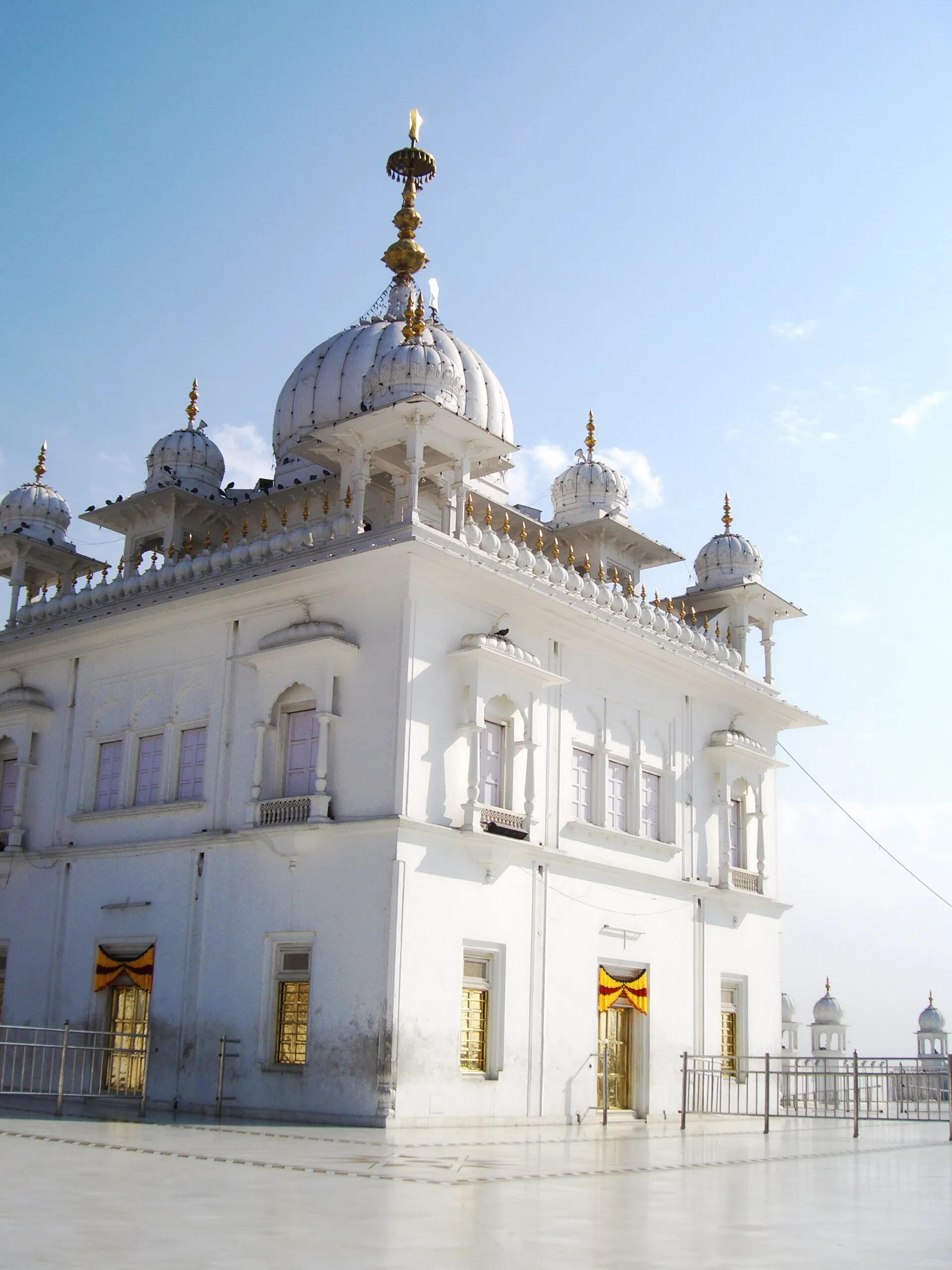 A historic gurdwara with white domes along the Sikh heritage trail in Punjab
