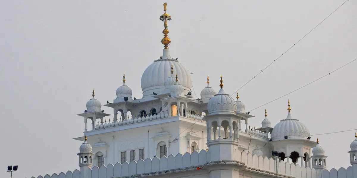 A historic gurdwara with white domes along the Sikh heritage trail in Punjab
