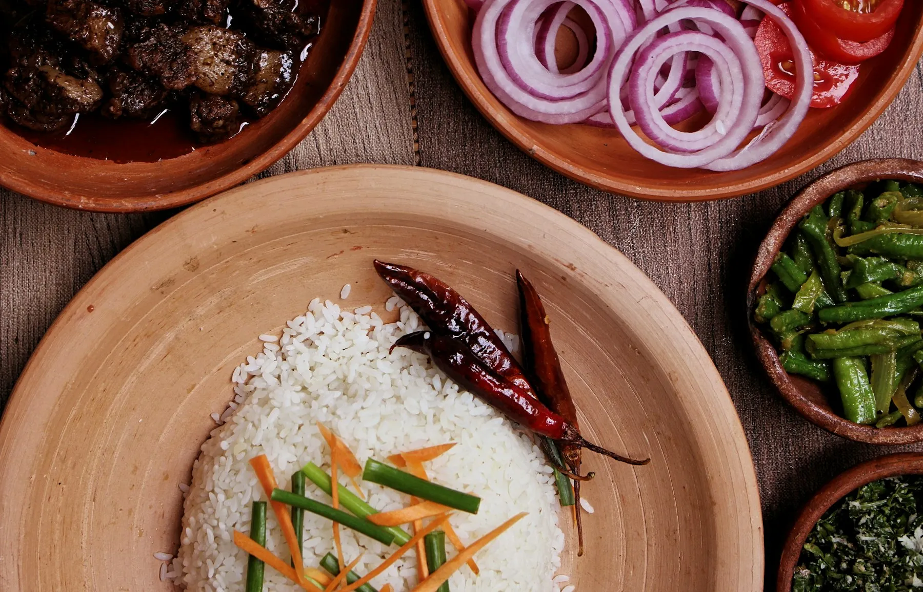 A Sri Lankan rice-and-curry meal spread with sambols, dahl and coconut