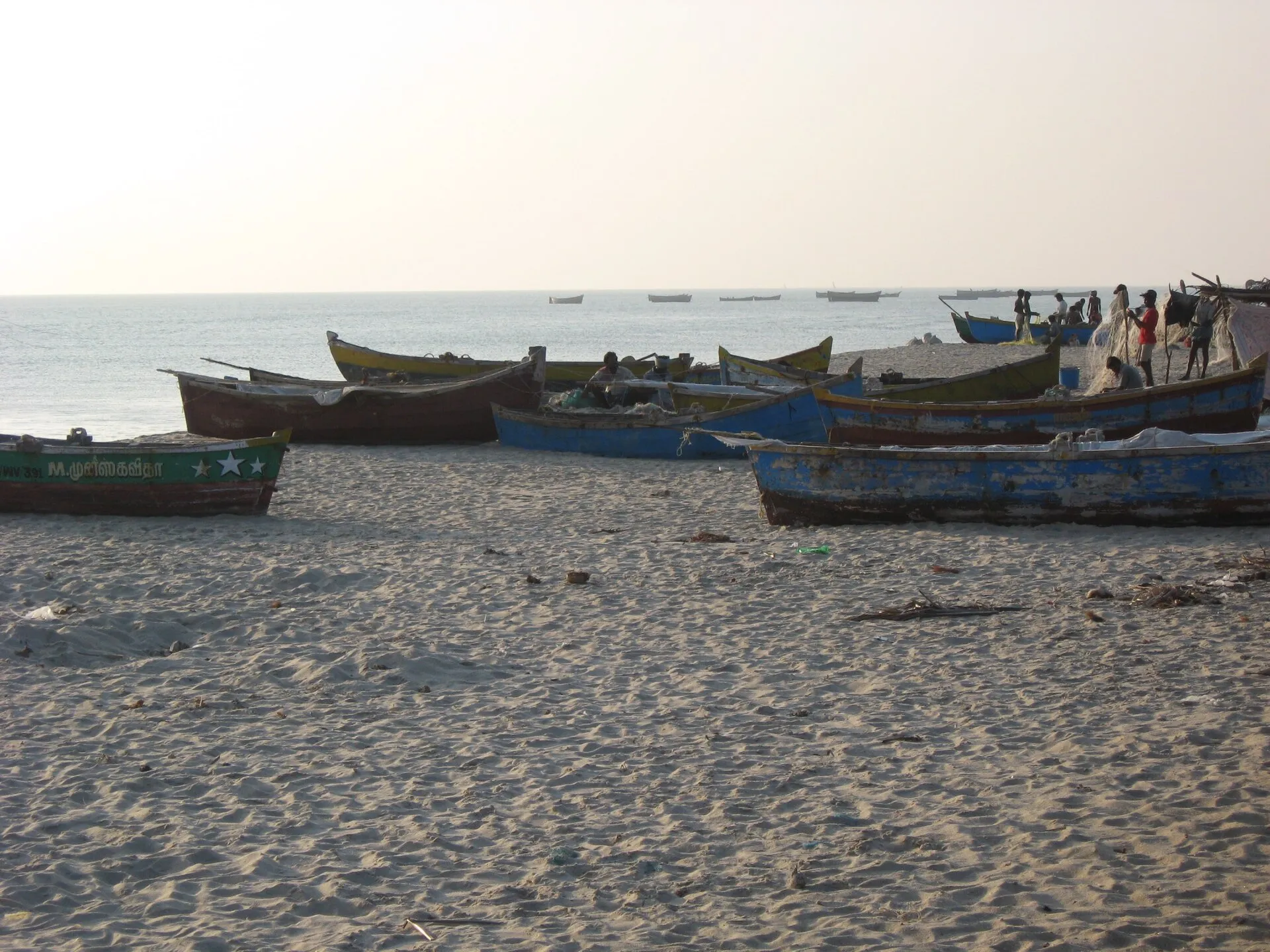 Wooden fishing boats drawn up on the beach at Rameshwaram, Tamil Nadu