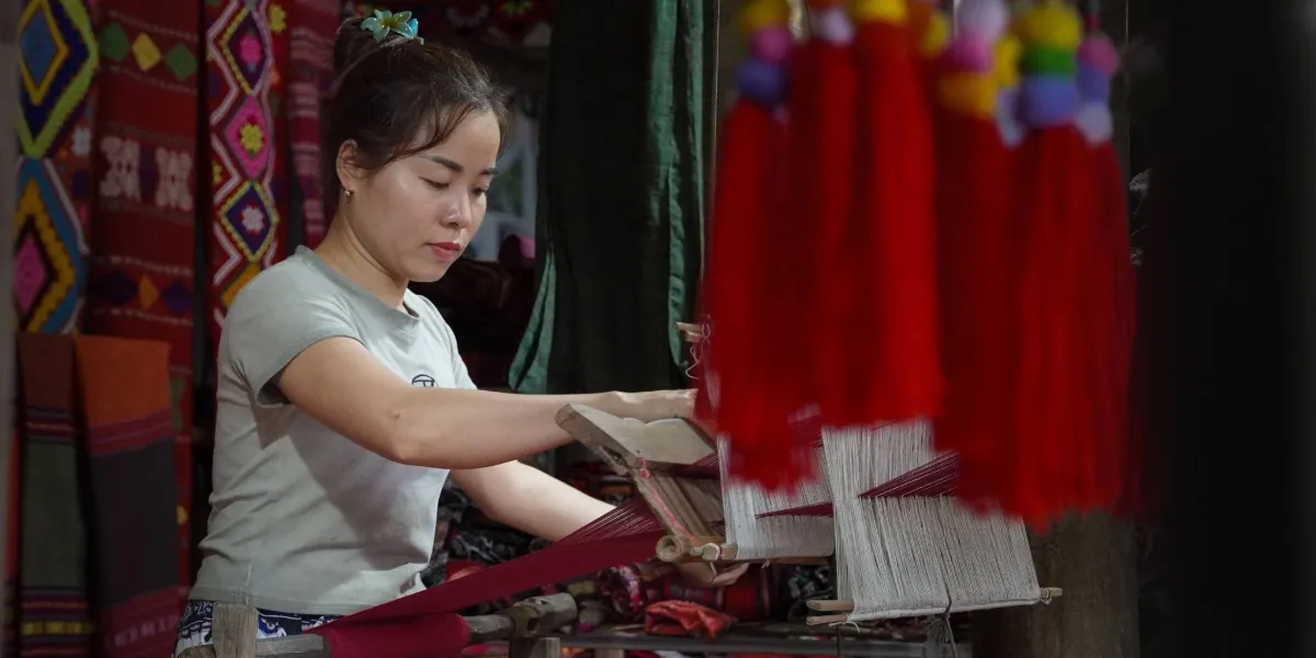 Brightly coloured handwoven Bhutanese yathra textile on a traditional loom