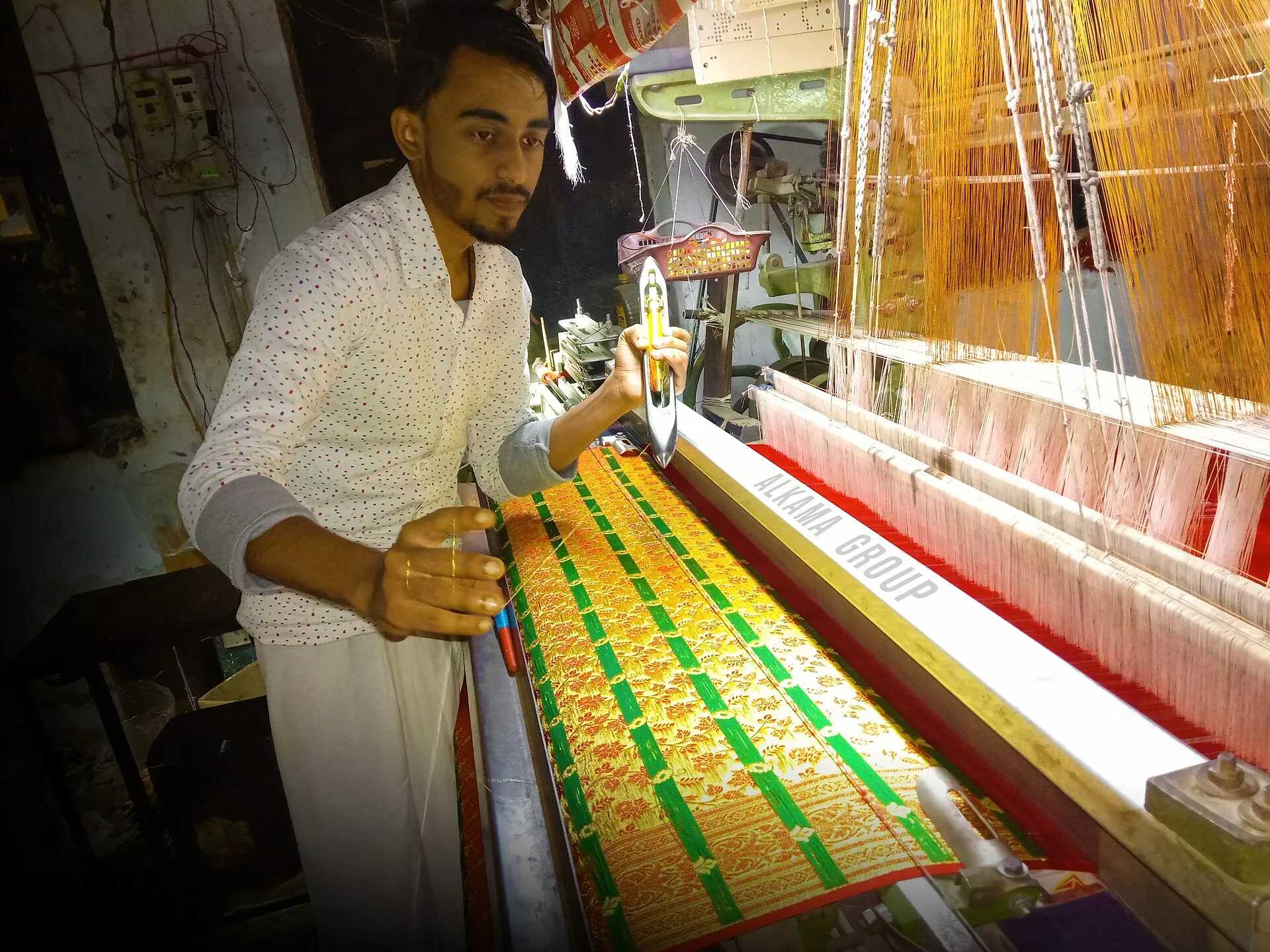 A weaver at a handloom working a Banarasi silk saree in Varanasi