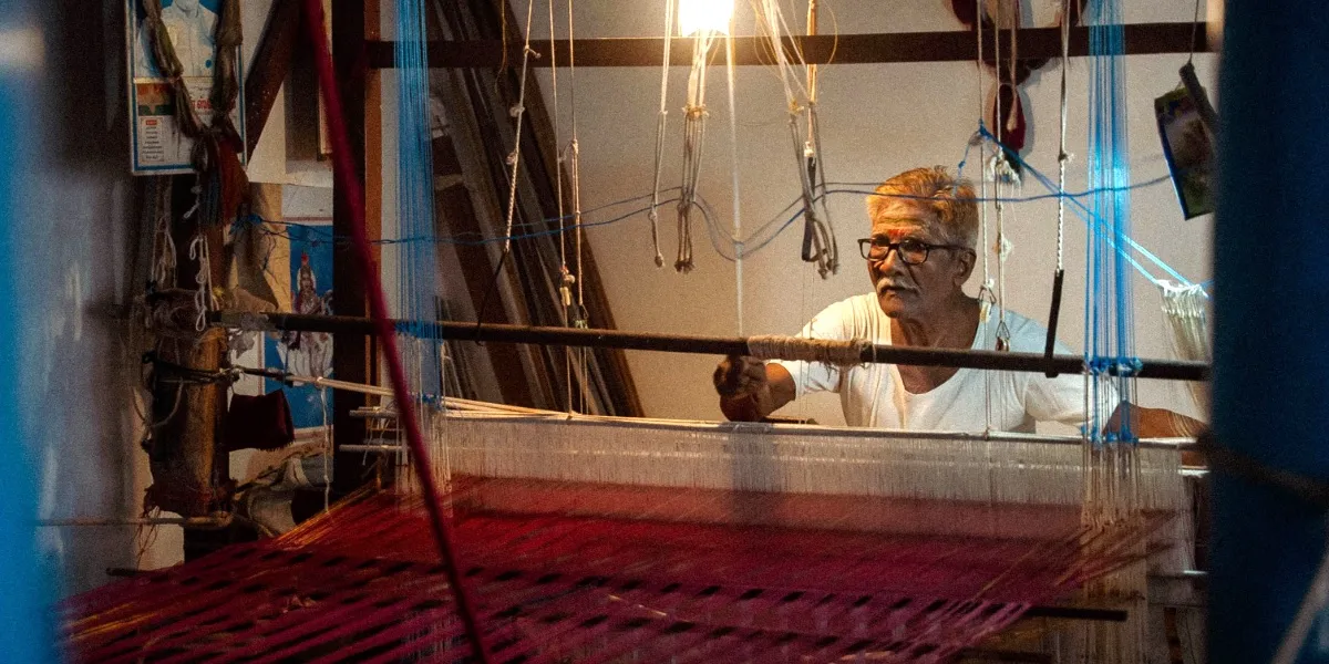 A weaver at a handloom working a Banarasi silk saree in Varanasi